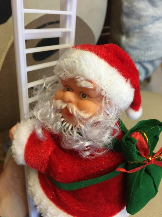 climbing santa on a ladder